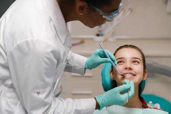 Should I Take My Child To A Kid Friendly Dentist In Jackson For White Spots On Teeth?